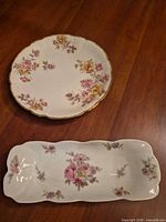 Round floral plate and rectangular éclair dish on tabletop