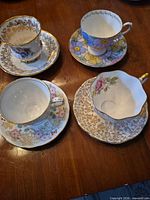 Four teacup and saucer sets displayed top view