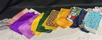 All 12 silk scarves laid out showing variety
