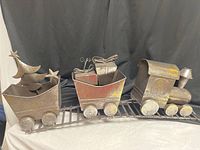 Full view of three-car metal Christmas train on track