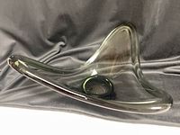 Side view of smoky gray freeform bowl showing curved rim and glossy finish
