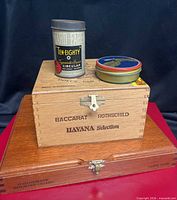 Stack showing all four items: Nat Sherman box base, Baccarat box, YARD•FABER tin, Camel round tin