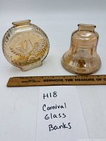 Both carnival glass banks with ruler for scale