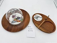 Both cheese boards, dome and spreader on white background