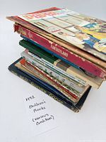 Stack of assorted children’s books showing spines and covers