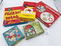 Five boxed games laid out showing titles