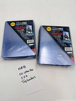 Two sealed packs of Ultra PRO 5"x7" toploaders with handwritten count note