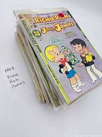 Stack of Richie Rich comics in sleeves with note H49