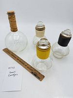 All four carafes with ruler for scale