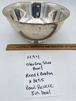 Overall view of sterling silver bowl with ruler and note card showing description