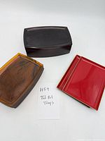 Stack of dark brown, red and amber trays showing quantity and color