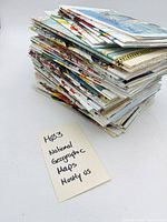 Full stack of folded National Geographic maps with handwritten note indicating lot