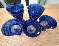 Front view of all five cobalt blue pressed-glass pieces
