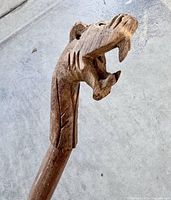 Close-up of carved animal head handle showing detail and condition