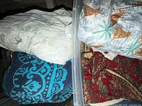 Overview showing comforter, fitted sheet, patterned towel and tapestry throw