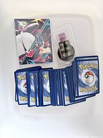 Portfolio, dice set in blister, spread of Pokémon cards