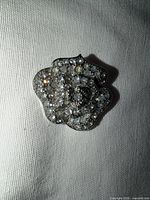 Front close view showing pavé stones and flower shape