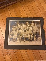 Front view of matted 1928 music concert photograph, shows group portrait and mat edge damage