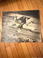 Full view of vintage aerial photograph placed on wood floor