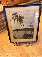 Front view of framed black & white palm tree photograph on stand
