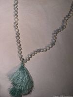 Close-up of bead detailing and tassel