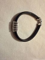 Full view of bracelet showing band, clasp and stone accent