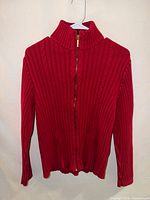 Front view of red zip-up ribbed sweater on hanger