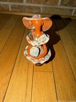 Front view of faceless ceramic figurine