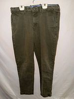 Front view of army green pants hanging