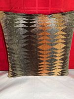 Front view of the square velvet pillow showing full geometric pattern