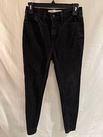 Front view of black high rise jeggings showing overall style and condition