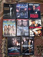 All eight DVD cases front view laid out on carpet