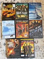 All eight DVD cases laid out on patterned surface