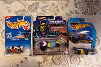 Front view of three sealed Hot Wheels cars