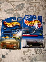 Front view of both sealed Hot Wheels cars on original cards