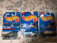 Front view of three sealed Hot Wheels cars