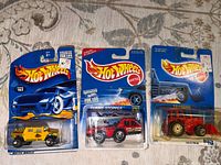 Front view of three sealed Hot Wheels cars on cards