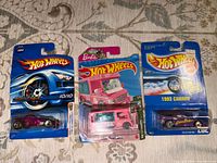 Front view of three sealed Hot Wheels blister cards