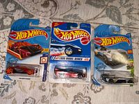 Front view of three sealed Hot Wheels blister cards
