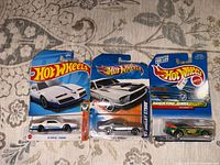 Front view showing three sealed Hot Wheels cars
