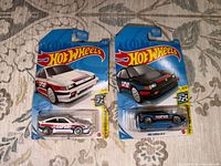 Front view of two sealed Hot Wheels 1985 Honda CR-X cars, white and black versions