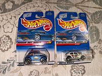 Front view of two Hot Wheels blister cards showing car designs and series names
