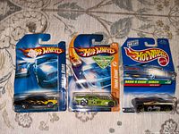 Front view of three sealed Hot Wheels cars on blister cards