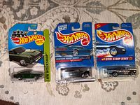 Front view of three sealed Hot Wheels cars on cards