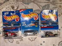 Front view of three sealed Hot Wheels cars