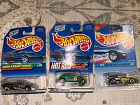 Front view of three sealed Hot Wheels cars