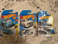Front view of three sealed Hot Wheels cars