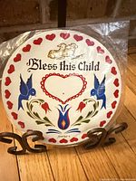 Front of sealed trivet showing design and inscription