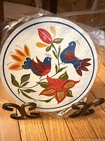 Front view of sealed 7.5-inch Pennsylvania Dutch Morning Birds trivet