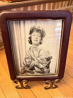 Front view of burgundy leather frame with black-and-white portrait
